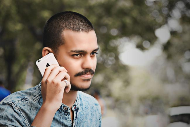 Anrufer blockieren: Man telefoniert sehr ernst, in der Hand, ein iPhone. Bild: Pexels/ Yogesh Borse (https://www.pexels.com/de-de/foto/selektive-fokusfotografie-des-mannes-der-gold-i-phone-halt-6-1484184/)